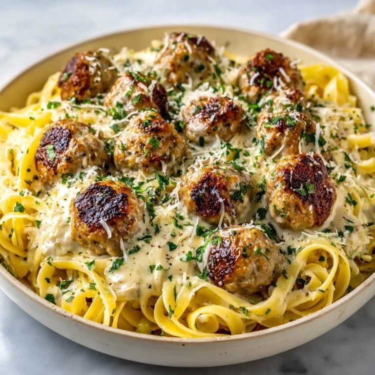Easy Garlic Butter Meatballs Served Over Creamy Parmesan Linguine Recipe